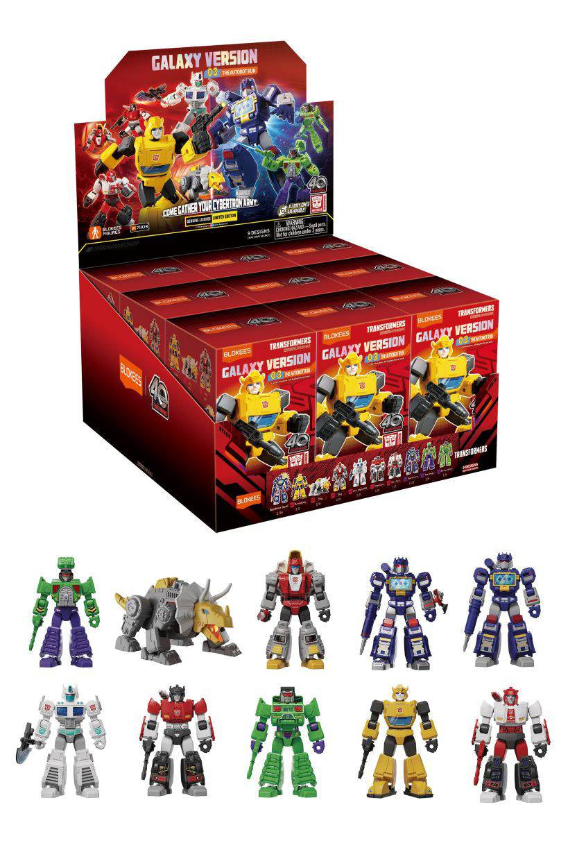 A collection of Transformers Galaxy Version 3 mini models displayed alongside their packaging which is red and features multiple Transformers images. The mini models appear in various colors and designs.