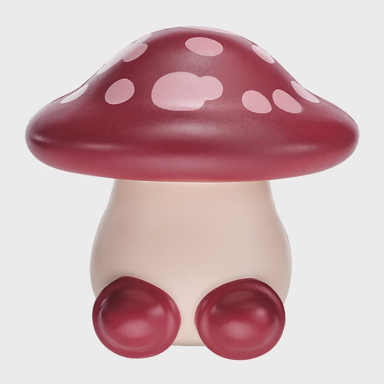 Mushroom-shaped figurine with a red cap and pink spots on a white background