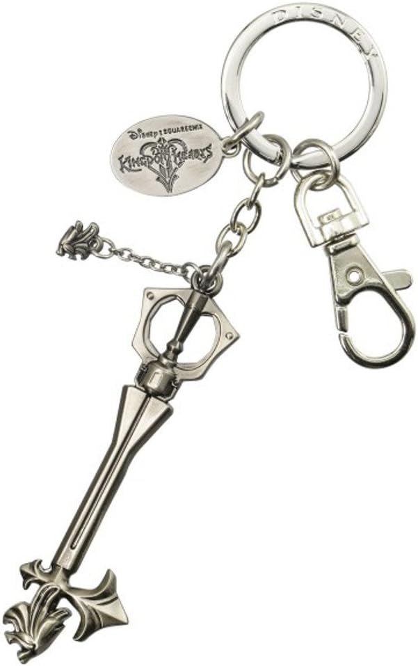 Silver key-shaped keychain with attached charms on a white background