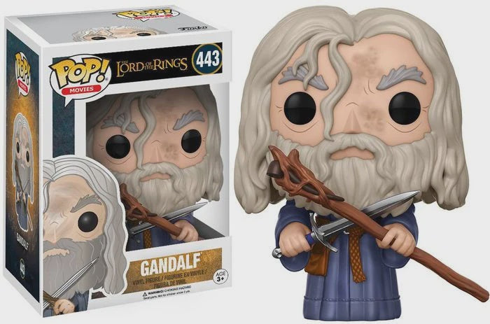 A vinyl figure of Gandalf from The Lord of the Rings, packaged in a window box. The figure depicts Gandalf in a contemplative pose, holding a staff, with a detailed design that captures his iconic look.