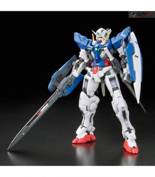 A completed model kit of the GN-001 Gundam Exia from the Japanese anime series, featuring the robot in white with blue and red accents, holding a sword.