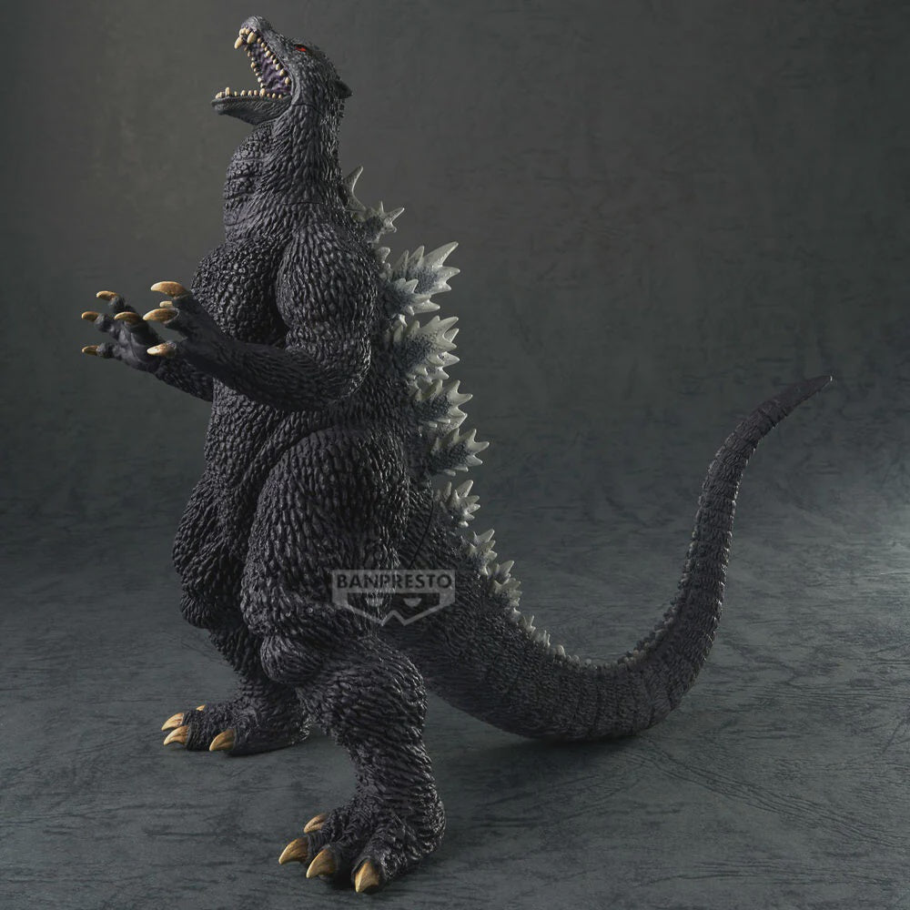 Godzilla figurine with textured body and open mouth on a dark background