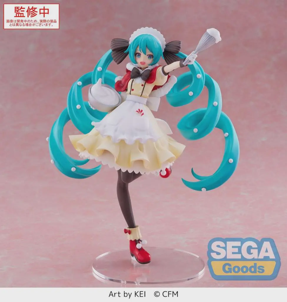 A collectible anime figure of Hatsune Miku in a maid outfit with turquoise twin-tails, posed on a clear round base against a soft pink studio background. Visible text includes SEGA Goods branding and 'Art by KEI © CFM'; the top-left red label appears to be a production-status overlay.