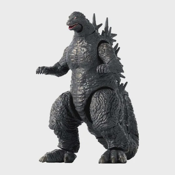 A 6-inch tall action figure of Godzilla in a standing pose with visible detailed texture on the body and spikes on the back.