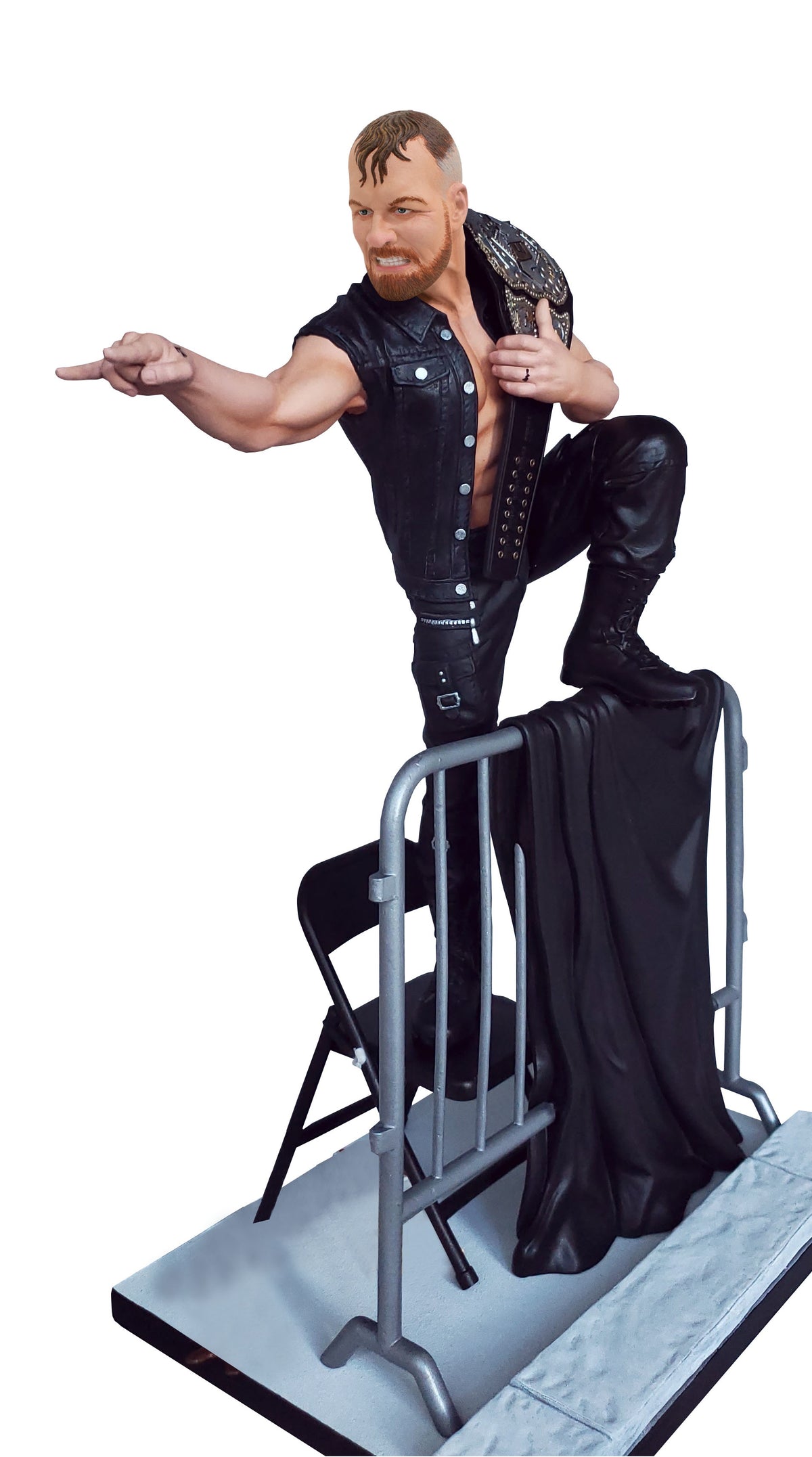 A PVC statue of All Elite Wrestling champion Jon Moxley, approximately 10 inches tall, standing on a chair with one foot on a barricade, holding a belt, and pointing forward.