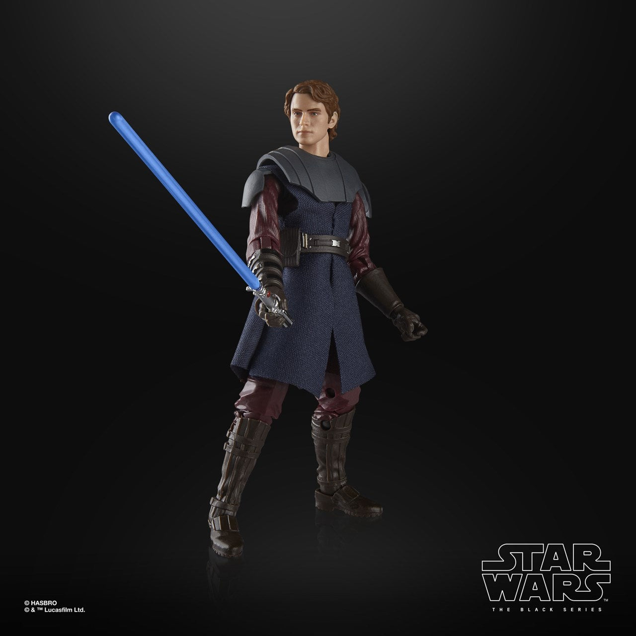 Star Wars action figure with a blue lightsaber on a black background