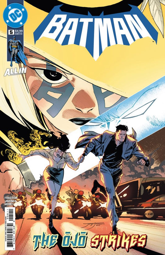 Comic book cover featuring Batman and a woman with a cityscape background