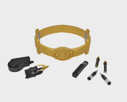 A yellow and black plastic accessory kit with a circular headband-like piece, a black round component, small black and yellow tools, and two pen-like items on a light gray background.