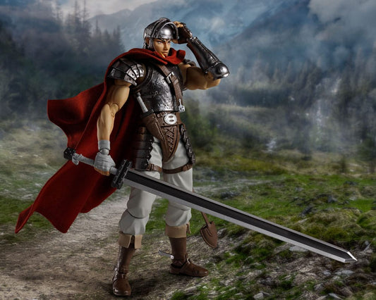Figure of a warrior in armor with a red cape and sword in a mountainous landscape