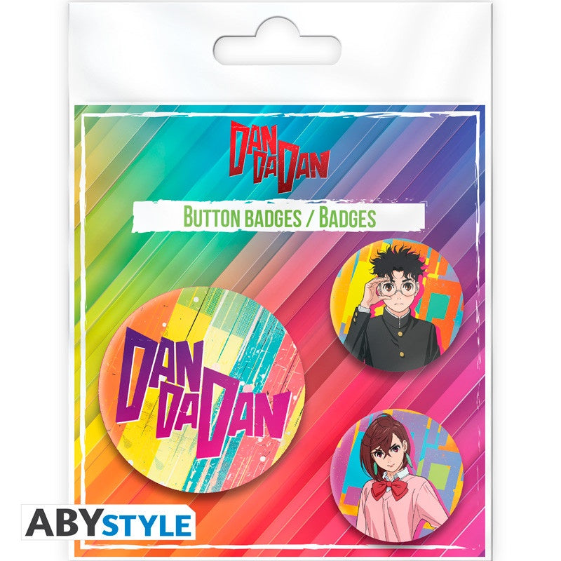 Packaged button badges with 'Dan Dan Dan' branding and colorful design.
