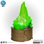 Green crystal-like object on a brown base with DC Direct logo.
