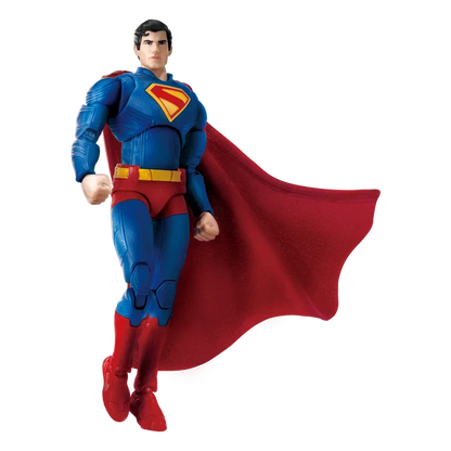Superman action figure in a flying pose, wearing a blue suit with a red cape and red belt, isolated on a white background.