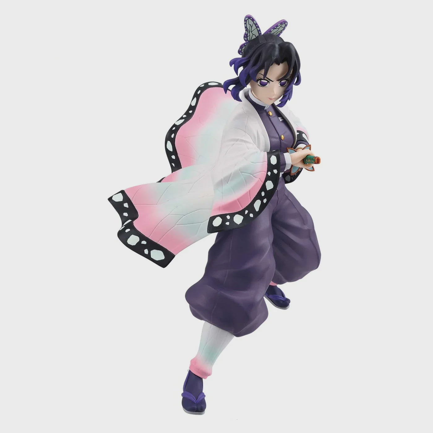 Anime character figurine in a dynamic pose on a light gray background