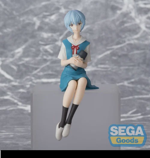 Anime character figurine with blue hair and school uniform sitting on a block, against a textured gray background with 'SEGA Goods' logo.