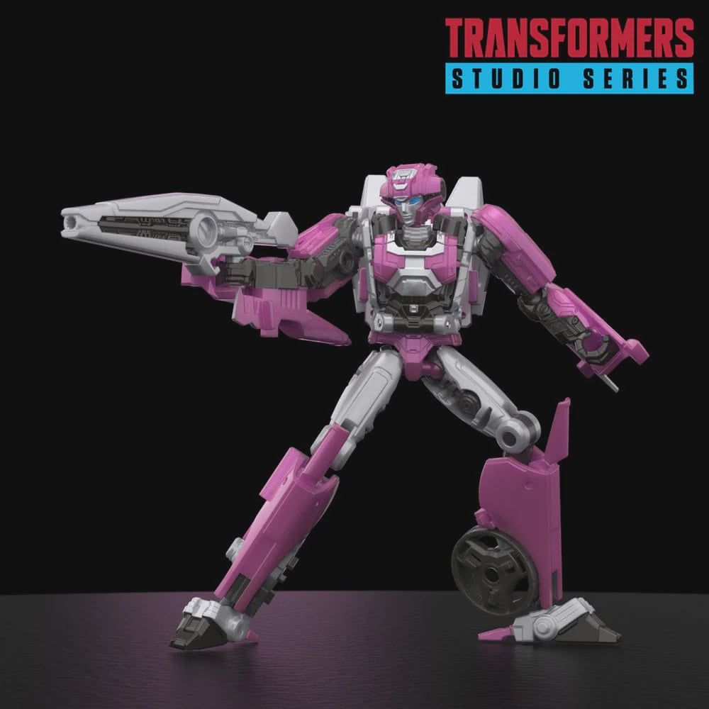 Transformers action figure with pink and gray design on a black background, featuring 'Transformers Studio Series' logo.