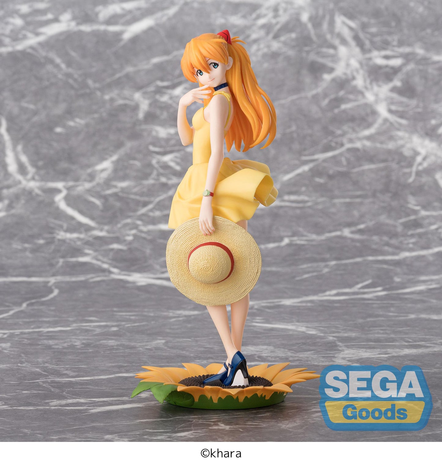 Figurine of a character with orange hair and a yellow dress, holding a straw hat, on a gray marble surface with 'SEGA Goods' branding.
Evangelion asuka summer dress 2 luminasta fig