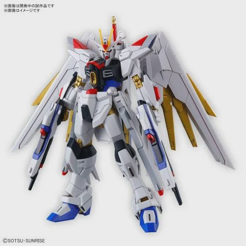 A model kit of the Mighty Strike Freedom Gundam from the GUNDAM series, featuring a white and red mecha with gold accents and blue wings.