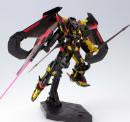A highly detailed collectible model of a mecha robot, featuring a black and gold body with red and black wings, holding a glowing pink sword on a black display base.
