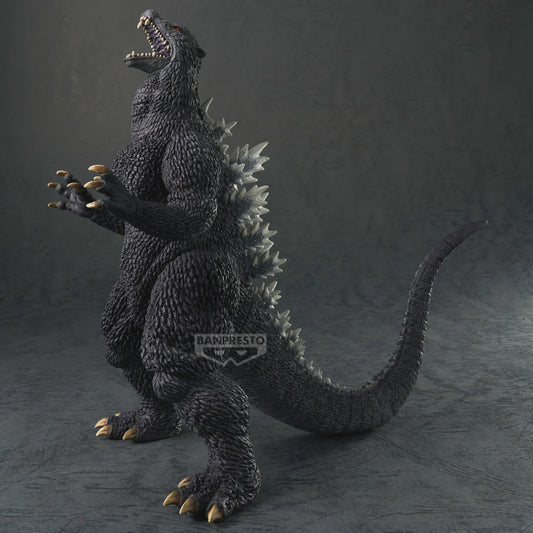 Godzilla figurine with textured body and open mouth on a dark background