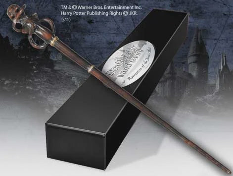 Wooden wand with silver top on a black box, surrounded by a dark forest background.