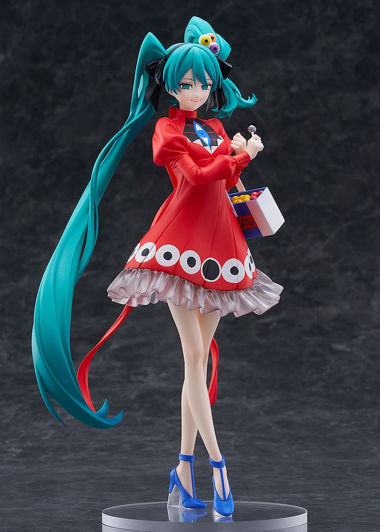Figurine of a character with teal hair and a red outfit on a dark background