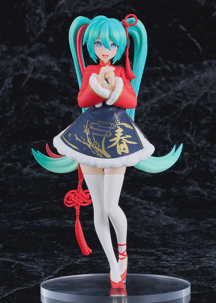 Anime character figurine with teal hair and red outfit on a dark background