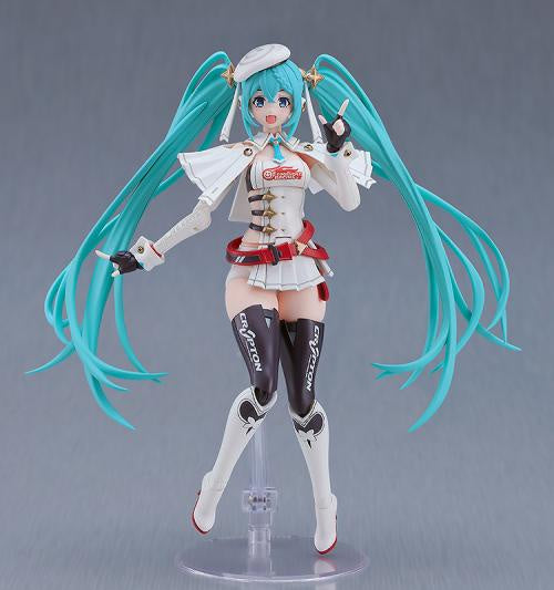 Anime character figurine with teal hair and white outfit on a gray background
