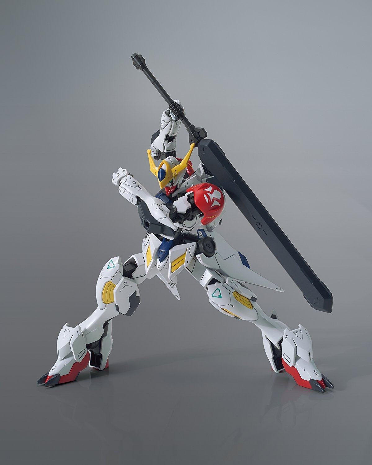 Model kit of a robot holding a large weapon on a gray background