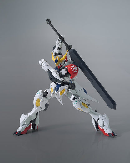 Model kit of a robot holding a large weapon on a gray background