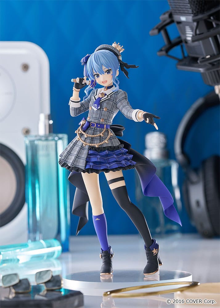 Action figure of a character with blue hair and plaid outfit standing on a reflective surface with a blue background.