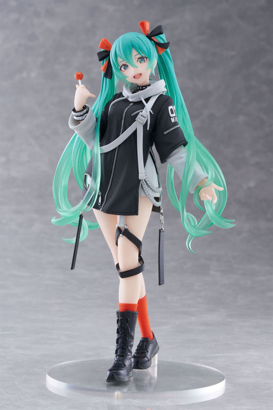 Anime character figurine with teal hair and black outfit on a gray background