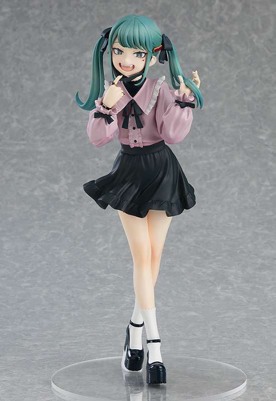 Anime character figurine with green hair and a pink shirt on a gray background