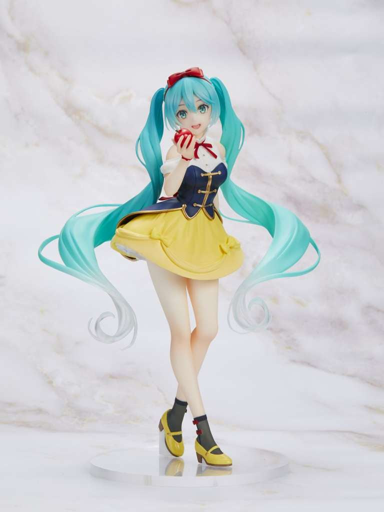 Anime character figurine with long turquoise hair and a yellow outfit on a light background