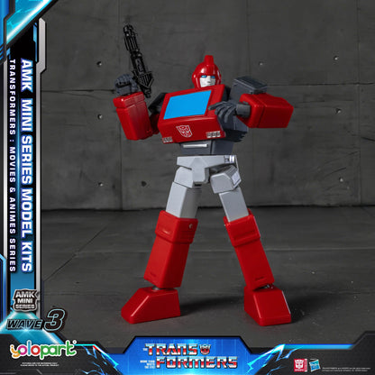 Red and gray robot toy figure with AMK Mini Series Model Kits branding on a dark background