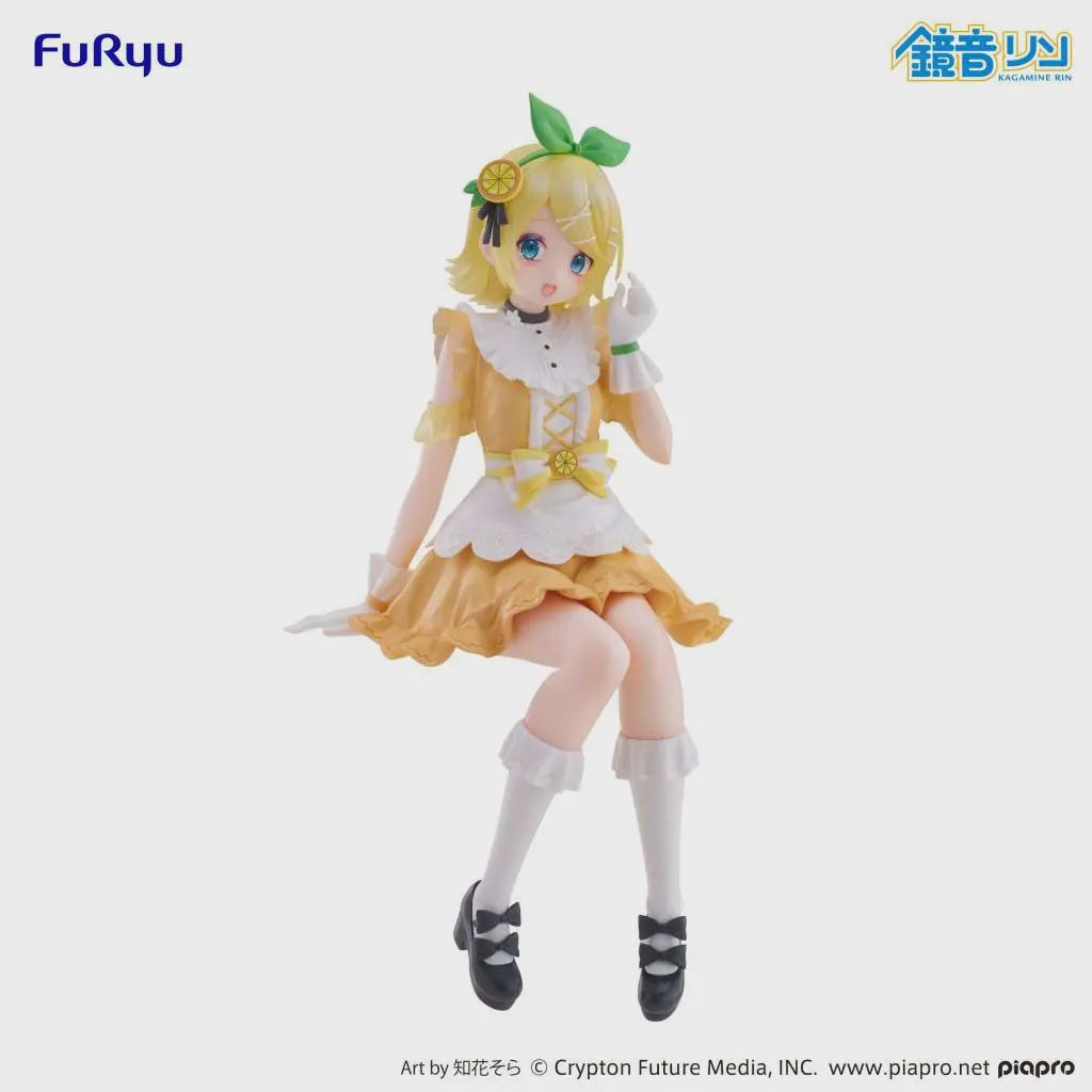 Figurine of a character in a yellow dress with a green bow, sitting on a white background.