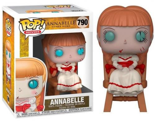 Funko Pop! Movies vinyl figure of Annabelle from The Texas Chainsaw Massacre, shown next to its original window box packaging. The figure features orange hair, a white dress with red accents, and large blue eyes, seated on a wooden chair.