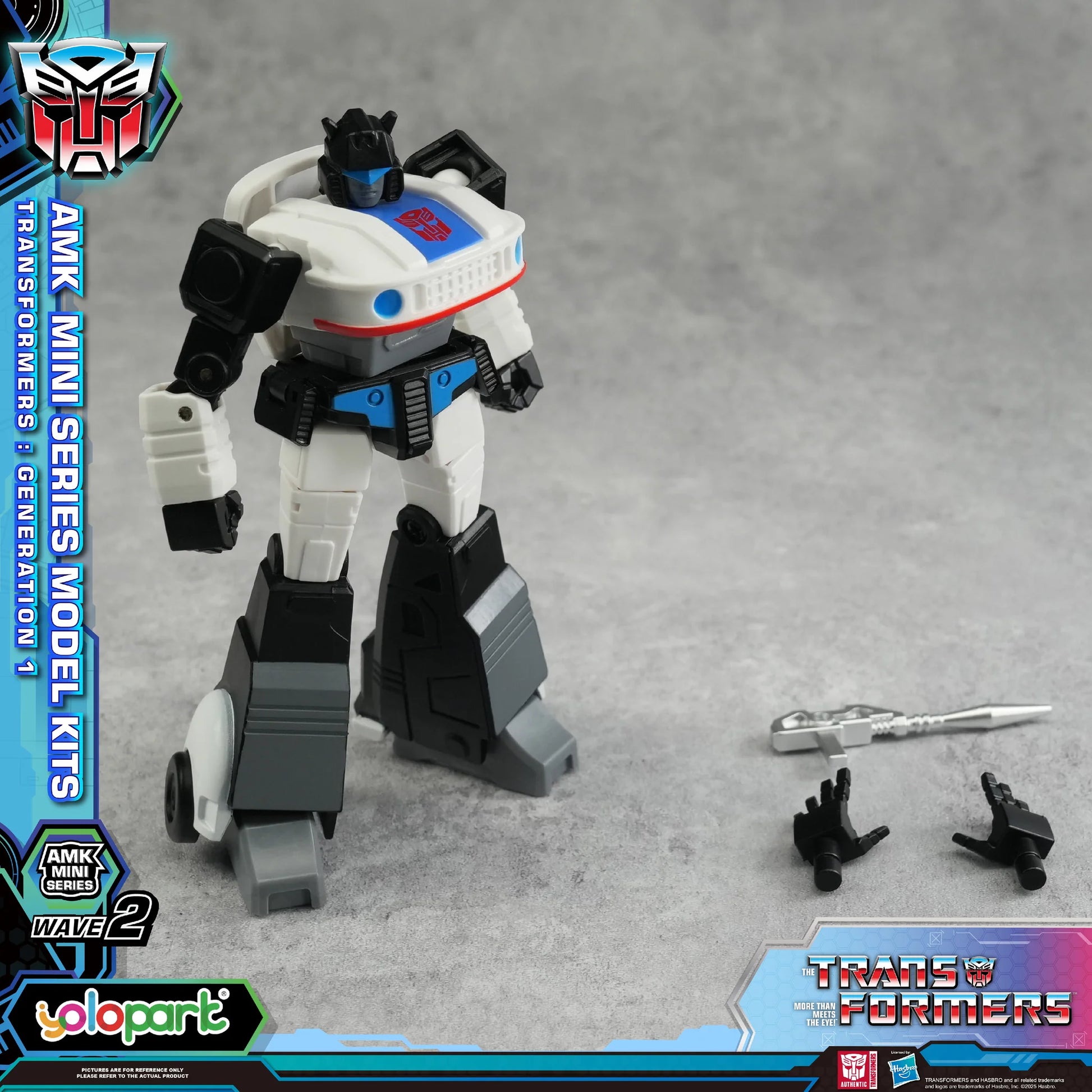 Transformers toy figure with accessories on a gray background, featuring AMK Mini Series branding.
