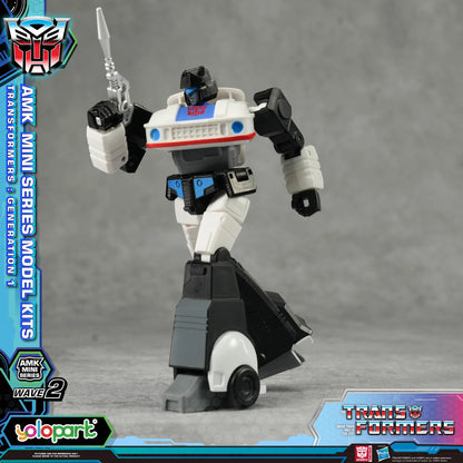 Transformers action figure with branding and packaging elements on a gray background