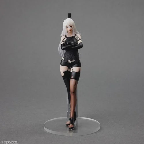 Action figure of a character in black and white attire on a gray background