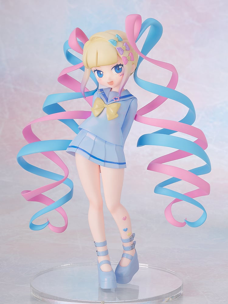 Figurine of a character in a blue outfit with colorful ribbons on a light background