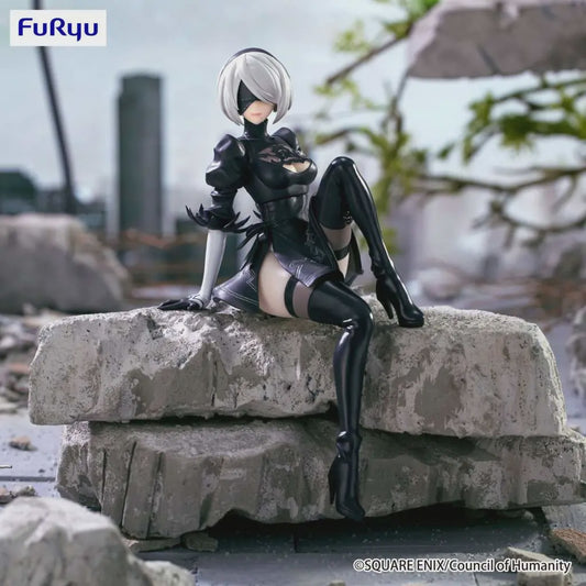 Figurine sitting on a rock with a blurred cityscape background, featuring the Furyu logo.
