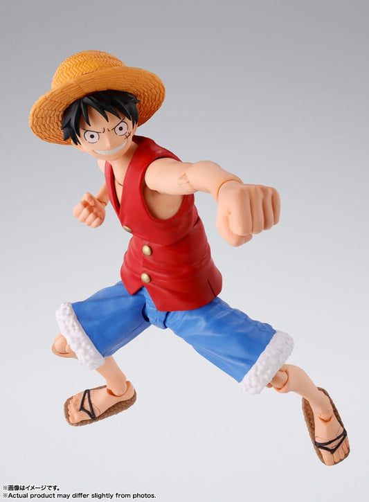 Action figure of a character in a red shirt and straw hat on a gray background