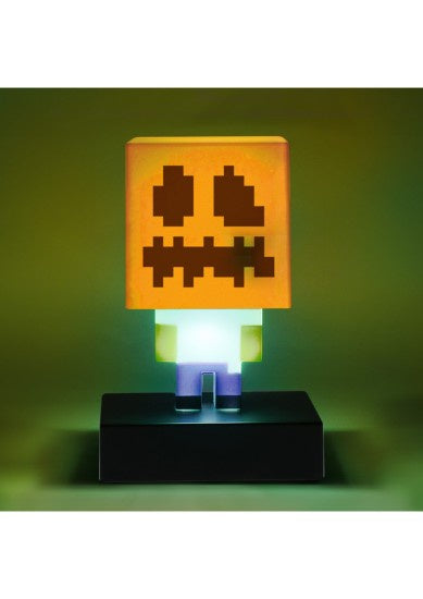 Lamp with a pumpkin face design on a green background