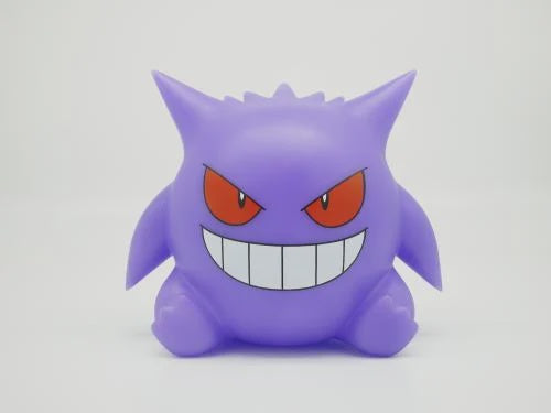 Purple cartoon character with red eyes and a wide grin on a white background