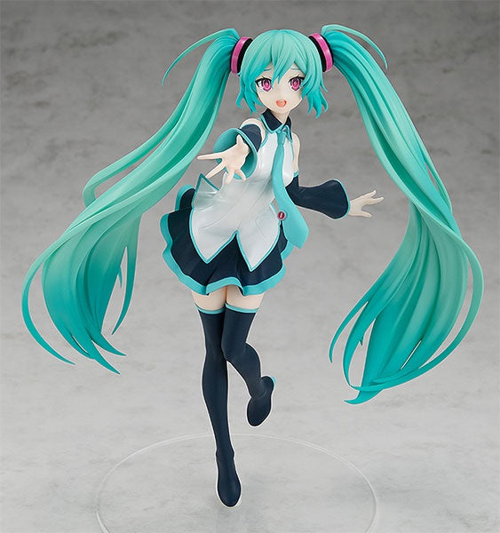 Anime character figurine with teal hair and a school uniform on a gray background