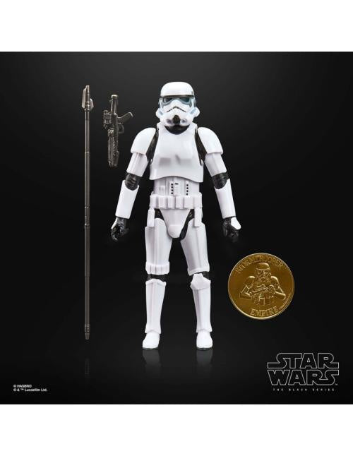 Star Wars action figure with a gold coin and lightsaber on a black background