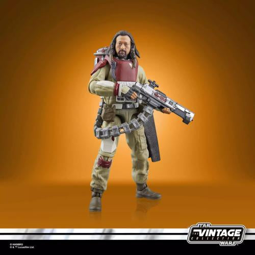 A Star Wars Vintage Collectibles action figure of a sci-fi warrior character holding a large blaster, posed against a warm orange gradient background. The figure has dark hair, a beard, and wears a beige and red outfit with utility details.