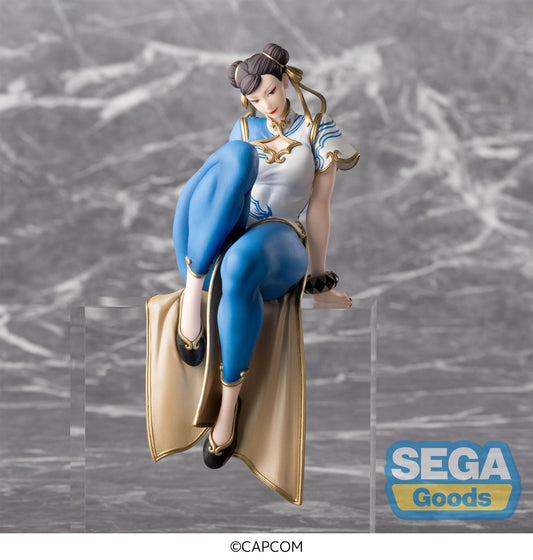 Figurine of a character in blue and white outfit with gold accents on a marble surface, featuring SEGA Goods logo.