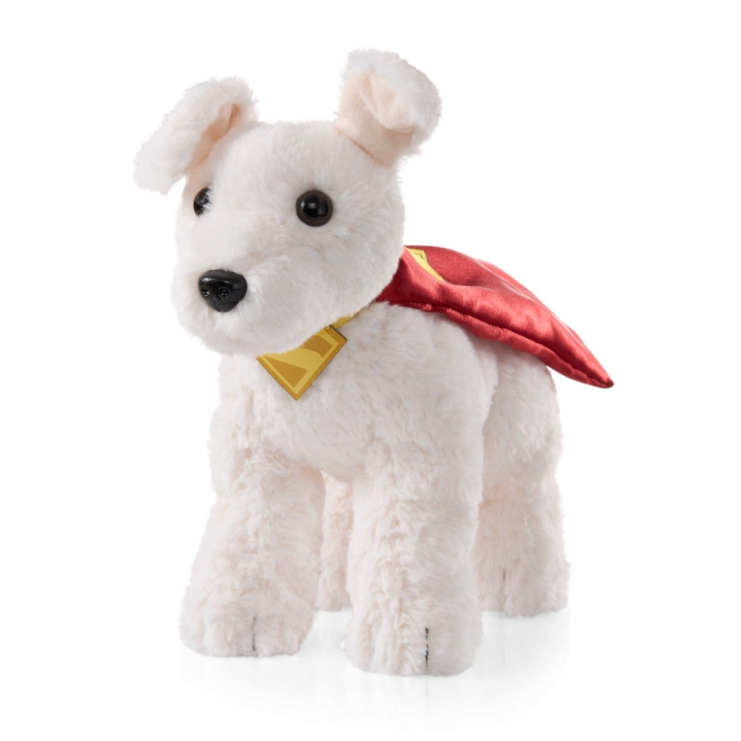 White plush dog toy with a red cape and yellow emblem on a white background