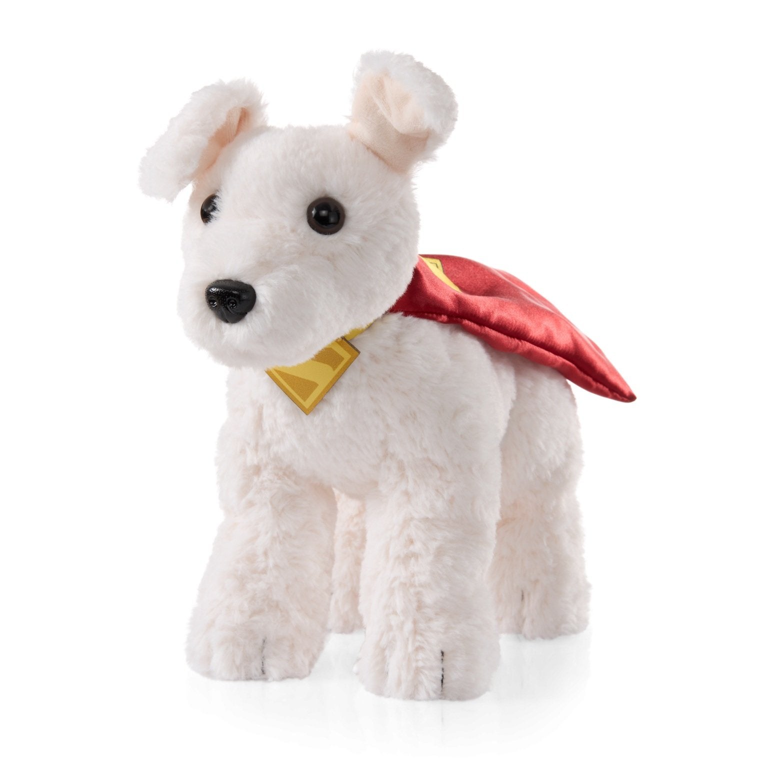 White plush dog toy with a red cape and yellow emblem on a white background